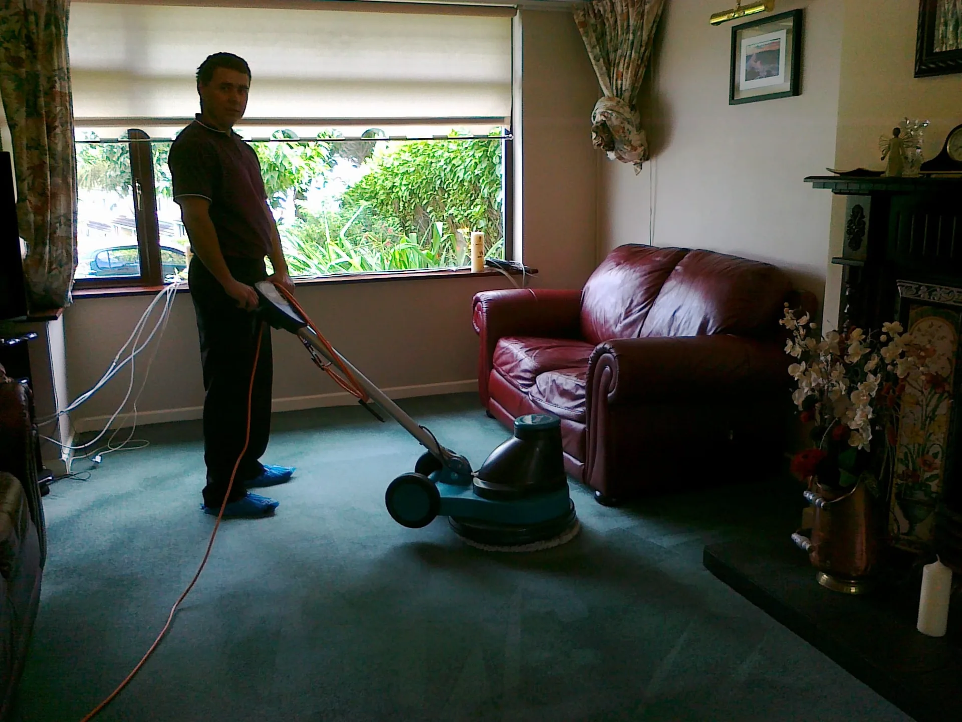 Professional carpet cleaning technician at work indoors