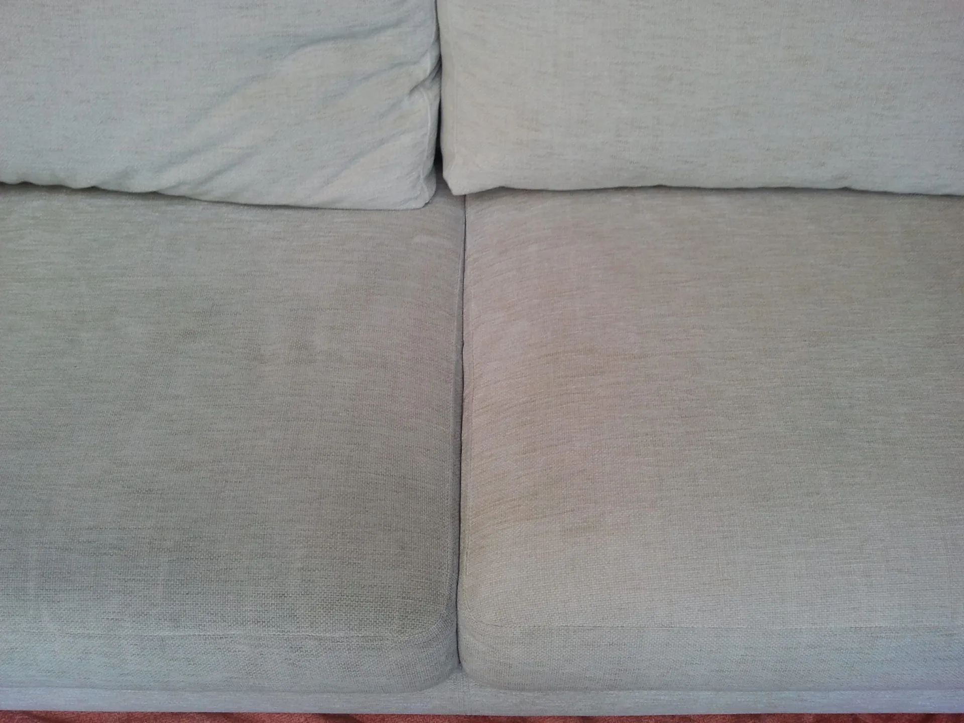 Professionally cleaned light gray fabric sofa