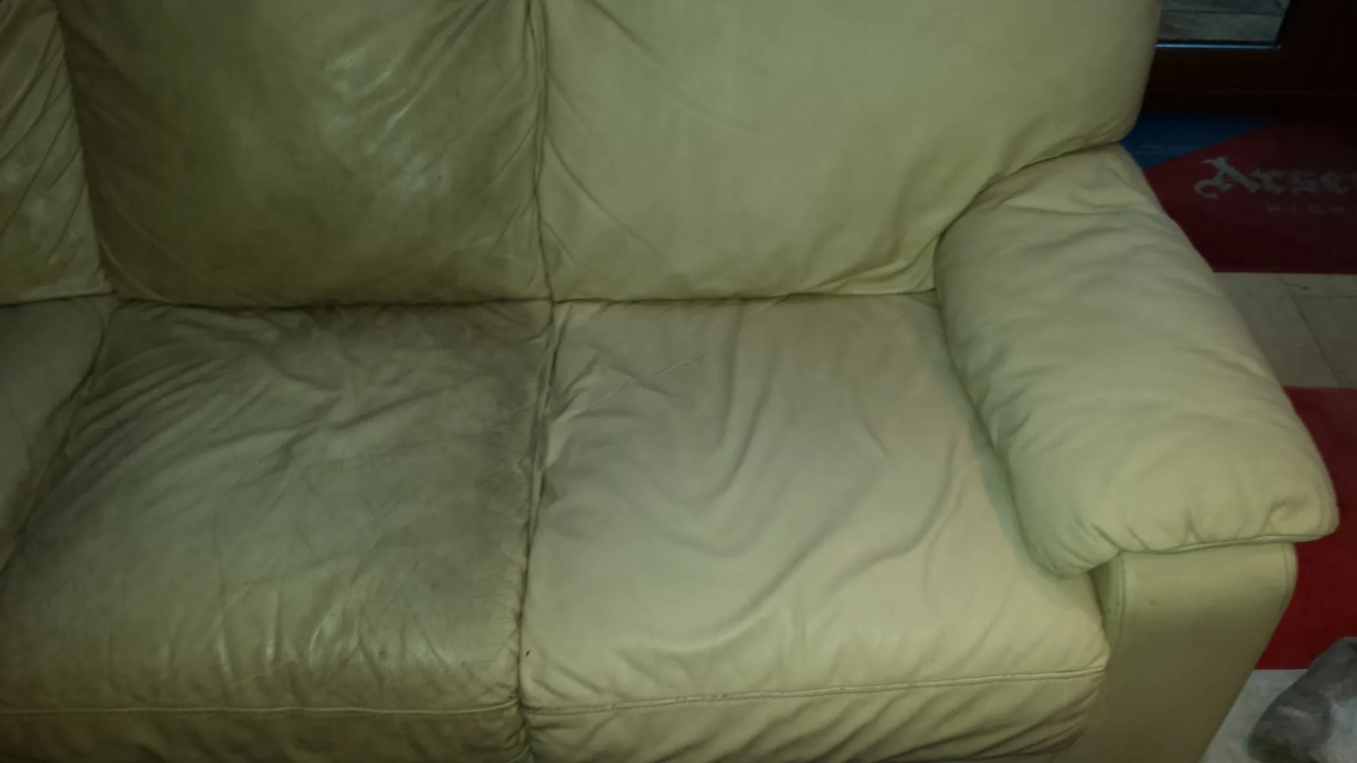 Cleaned cream leather upholstered sofa