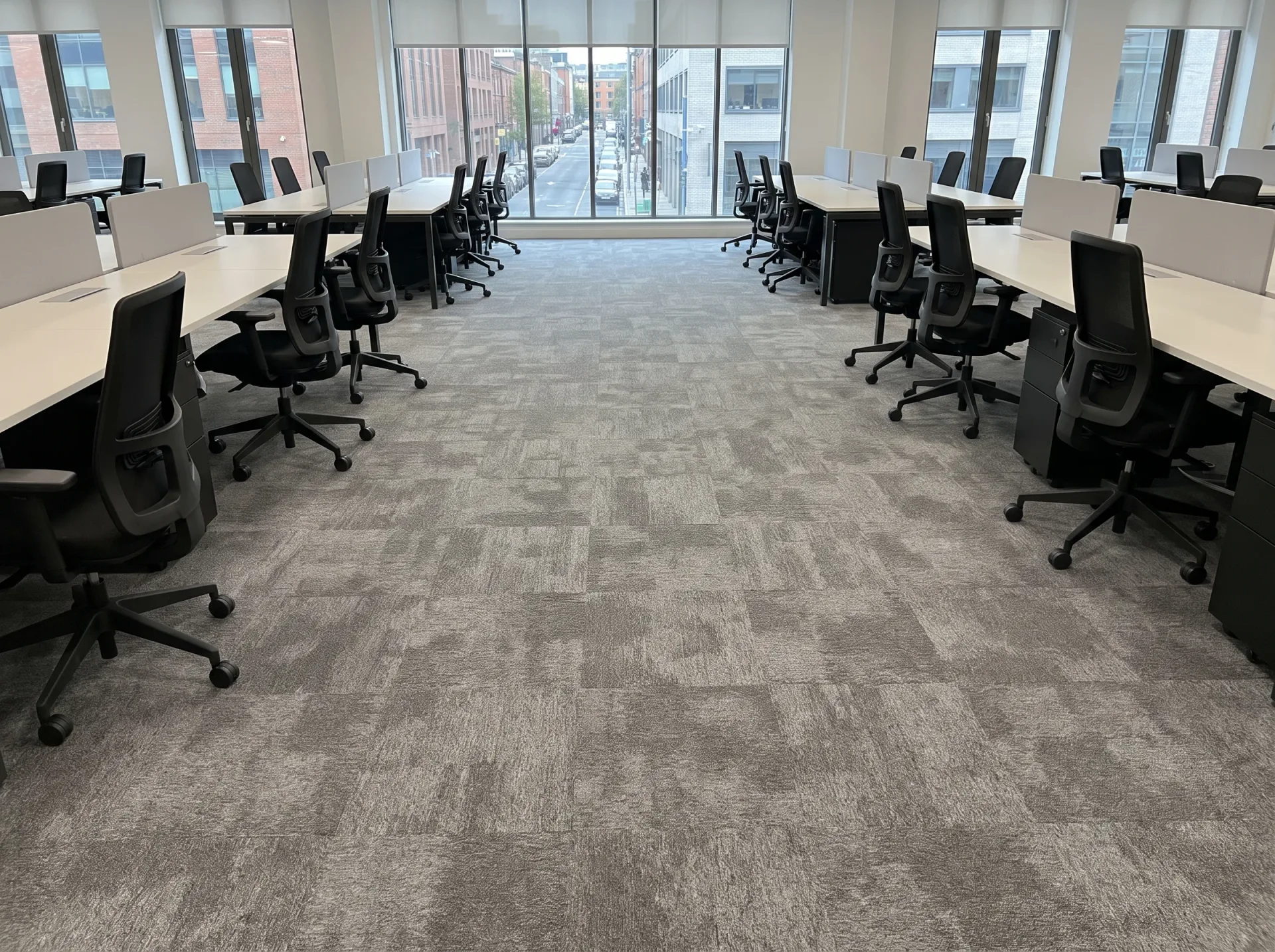 Professionally cleaned office carpet with geometric tile pattern in modern commercial workspace