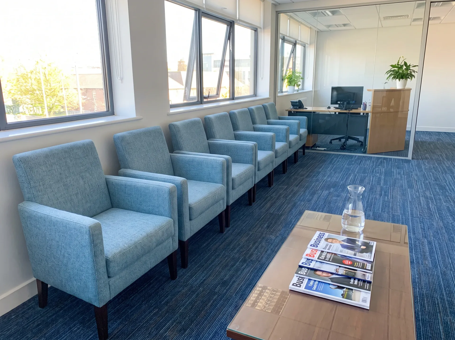 Blue upholstered office chairs and commercial carpet in modern business workspace