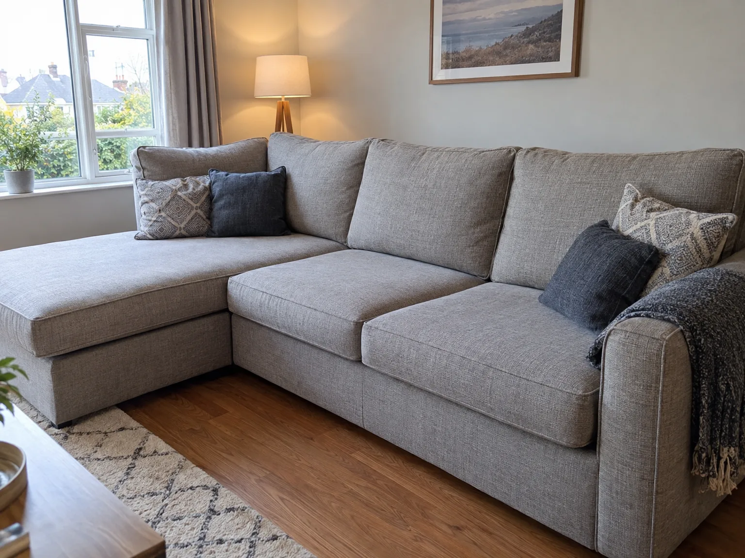 Professional sofa cleaning: pristine gray sectional upholstery in bright living room
