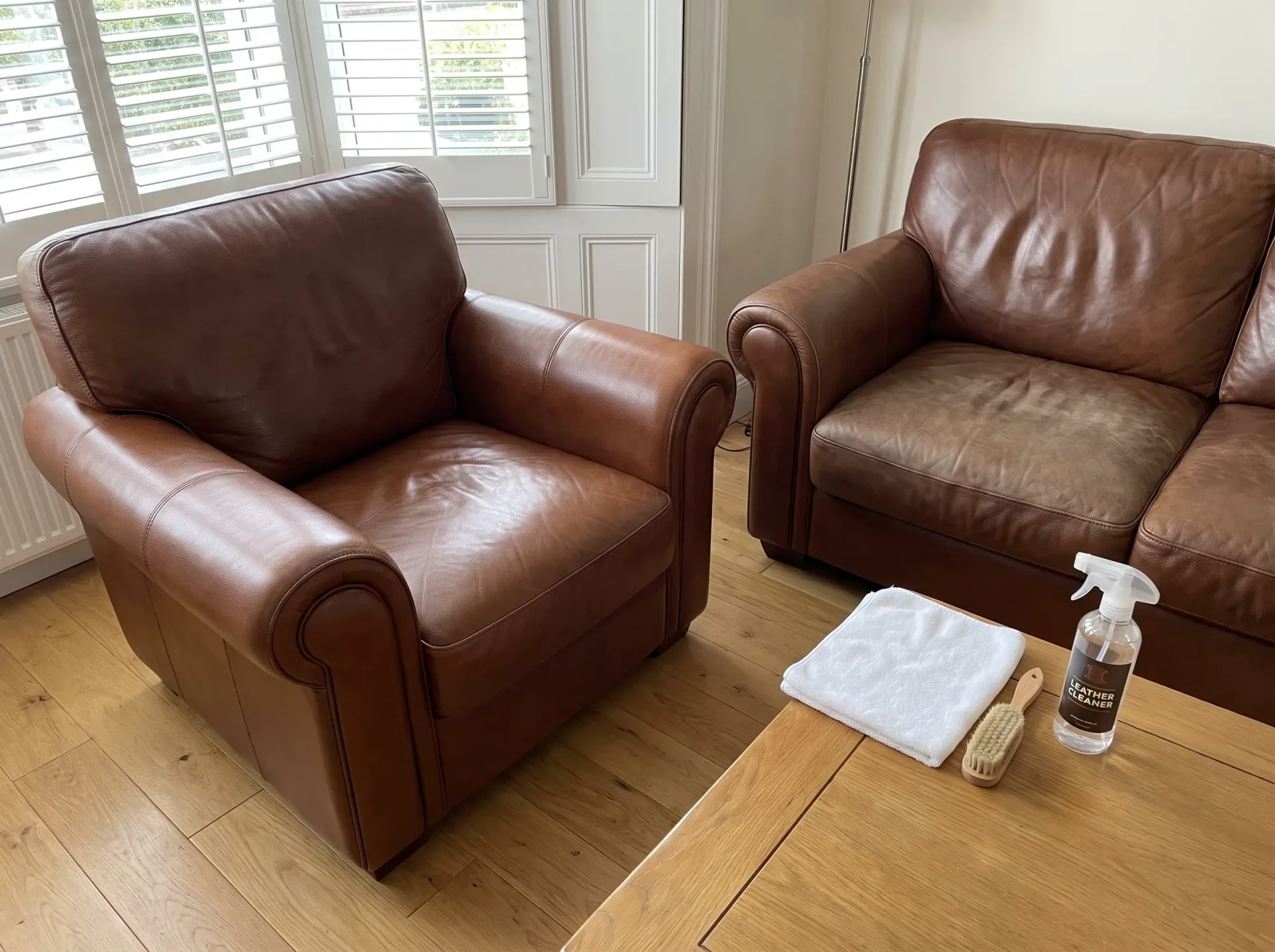 Brown leather armchairs with professional cleaning supplies, ready for Leather Upholstery Cleaning service