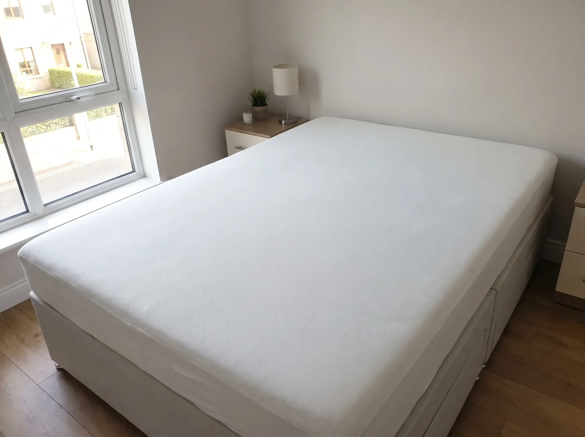 Freshly cleaned white mattress in modern bedroom showing professional mattress cleaning results
